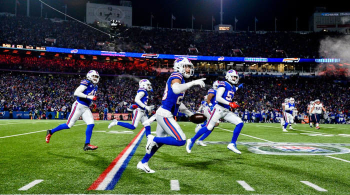 Buffalo Bills safety Micah Hyde, center, celebrates after catching an interception during the first half of an NFL wild-card playoff football game against the New England Patriots, Saturday, Jan. 15, 2022, in Orchard Park, N.Y.